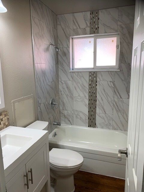 Renovated bathroom with tile tub surround and mosaic accent