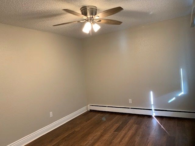 Bedroom with ceiling fan and wood-style plank flooring