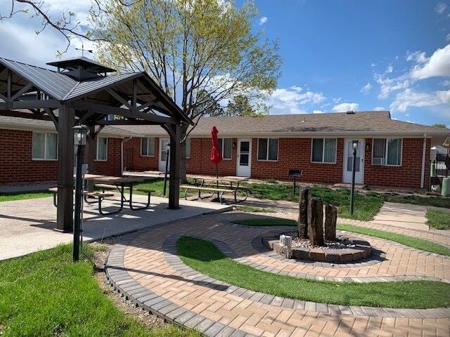 Covered picnic pavilion and fire pit in the paver courtyard