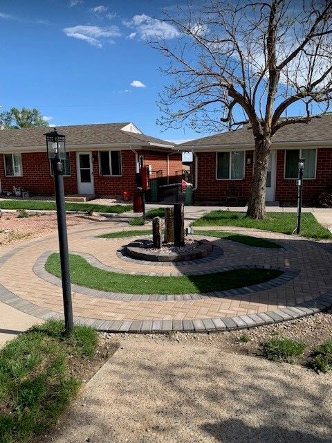 Paver courtyard with water feature and lamp posts