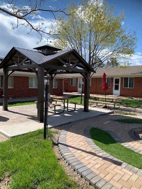 Covered pavilion with picnic seating beside the courtyard